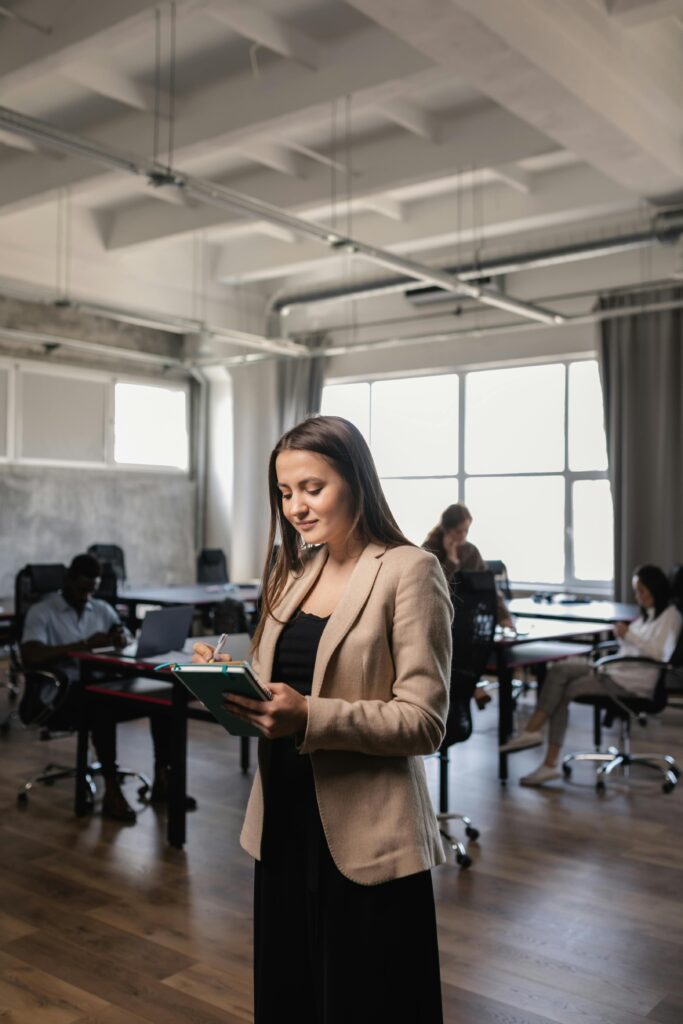 pexels-photo-7707015-7707015 Professional woman planning and working with colleagues in a modern office setting.